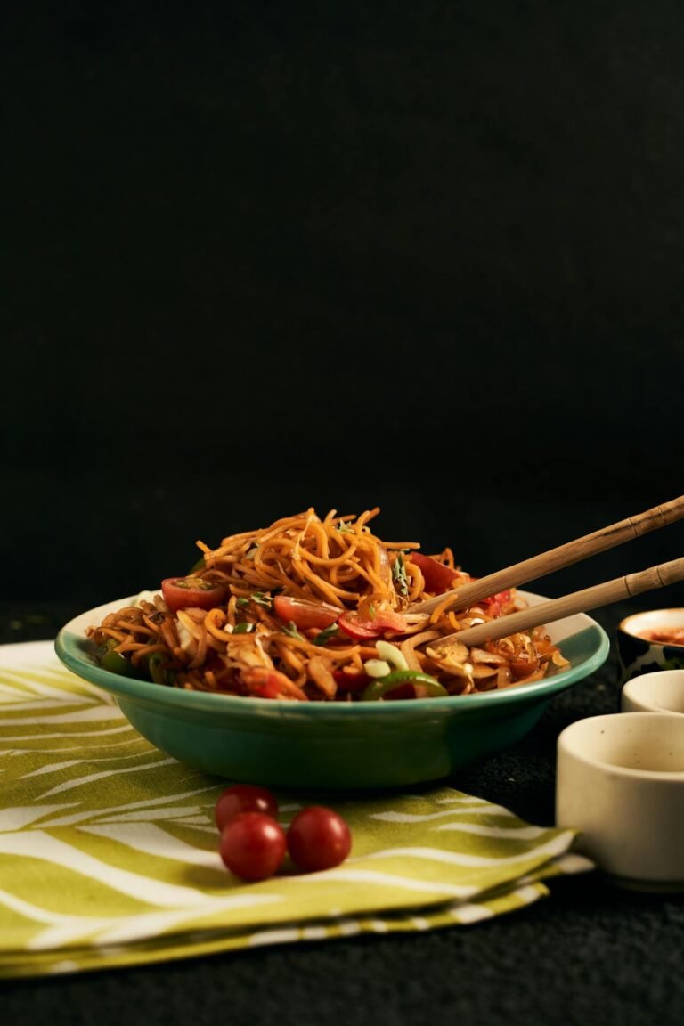 Close-up of vegan noodles with chopsticks, perfect for food photography.